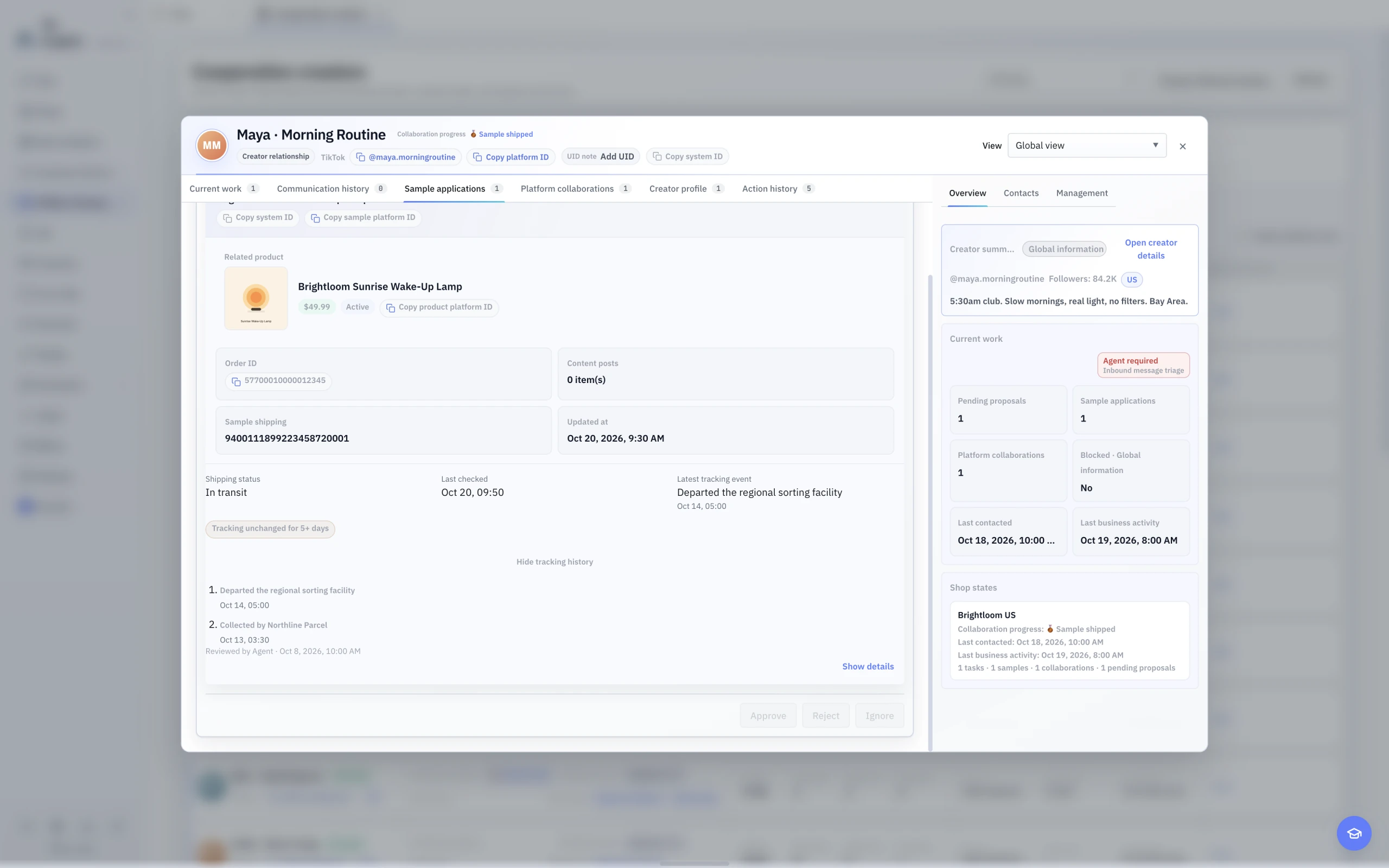 The English light-theme Sample shipping detail with order state, last checked time, a stalled-shipment warning, and expandable tracking events.